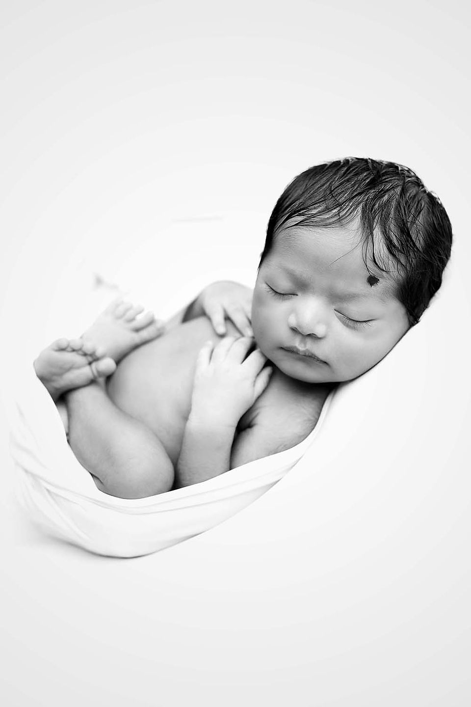 Classic, Unique and timeless ball and white portrait of a newborn baby boy taken at Frisco Newborn Photography studio 