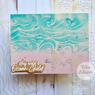 Greeting card featuring beach scene with sand, waves, and starfish