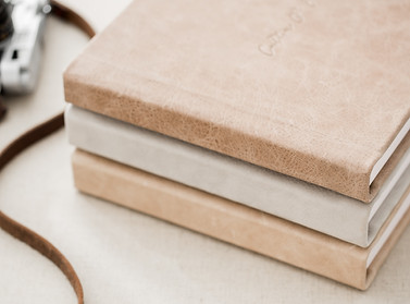 a stack on neutral colored fine art albums