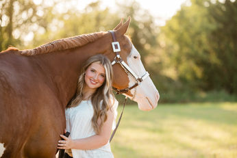 a blonde girl hugging her APHA gelding at sunset at Lucky 13 Ranch in Arlington, Washington
