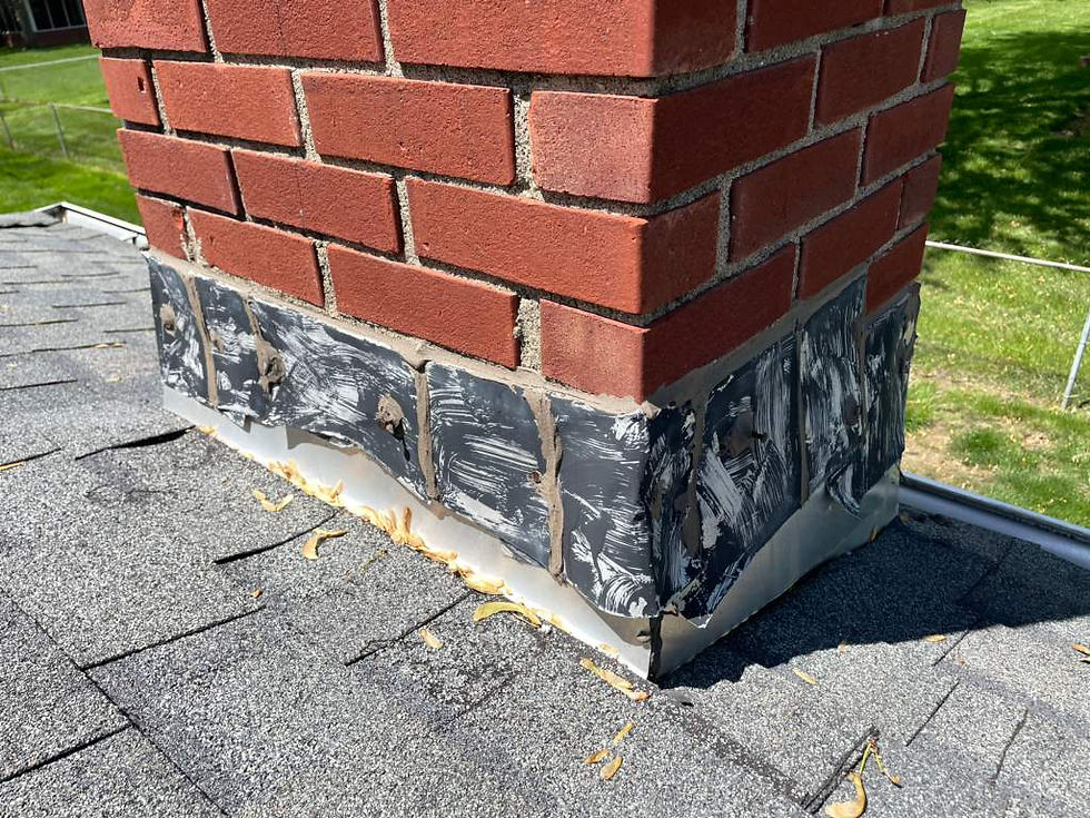 Damaged metal flashing around a brick chimney