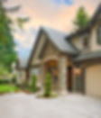 Photo of a nice house with stone siding and a well kept yard.