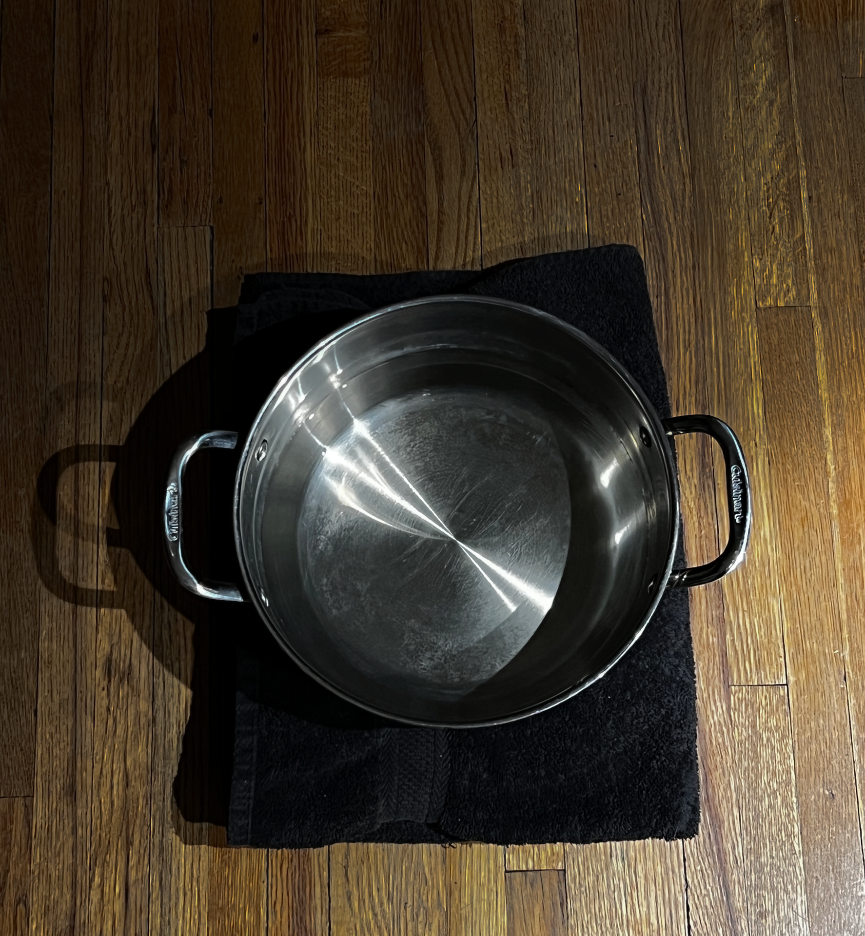 Pot of water on the ground sitting on a towel