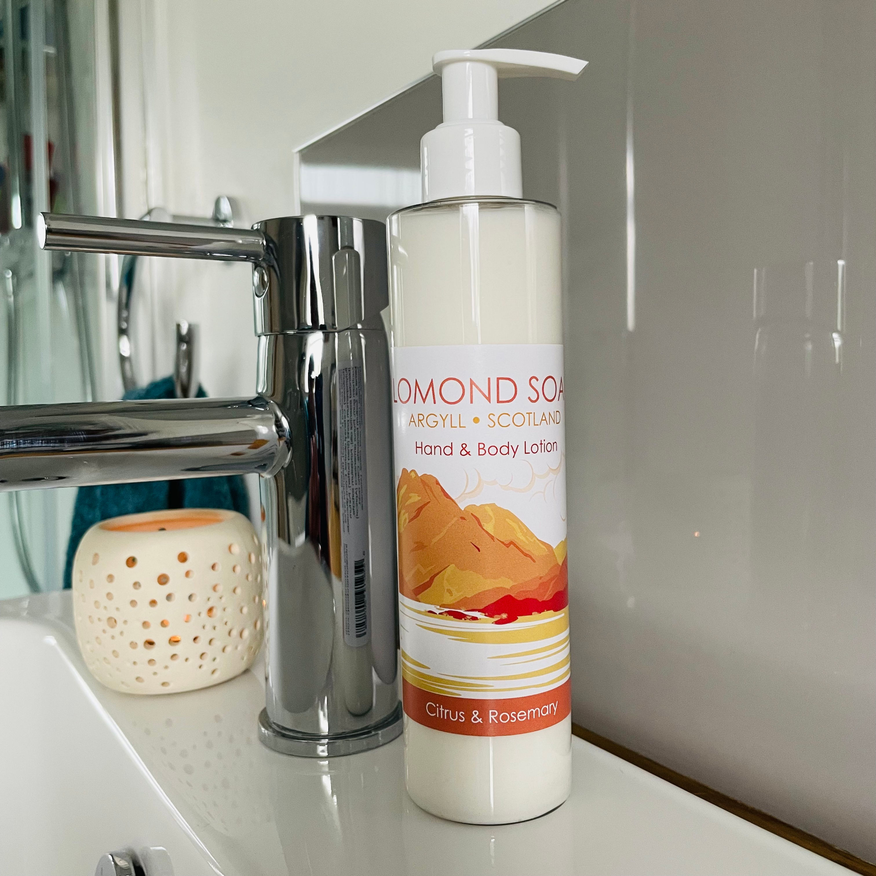 Bottle of lotion sitting on edge of basin with orange label.