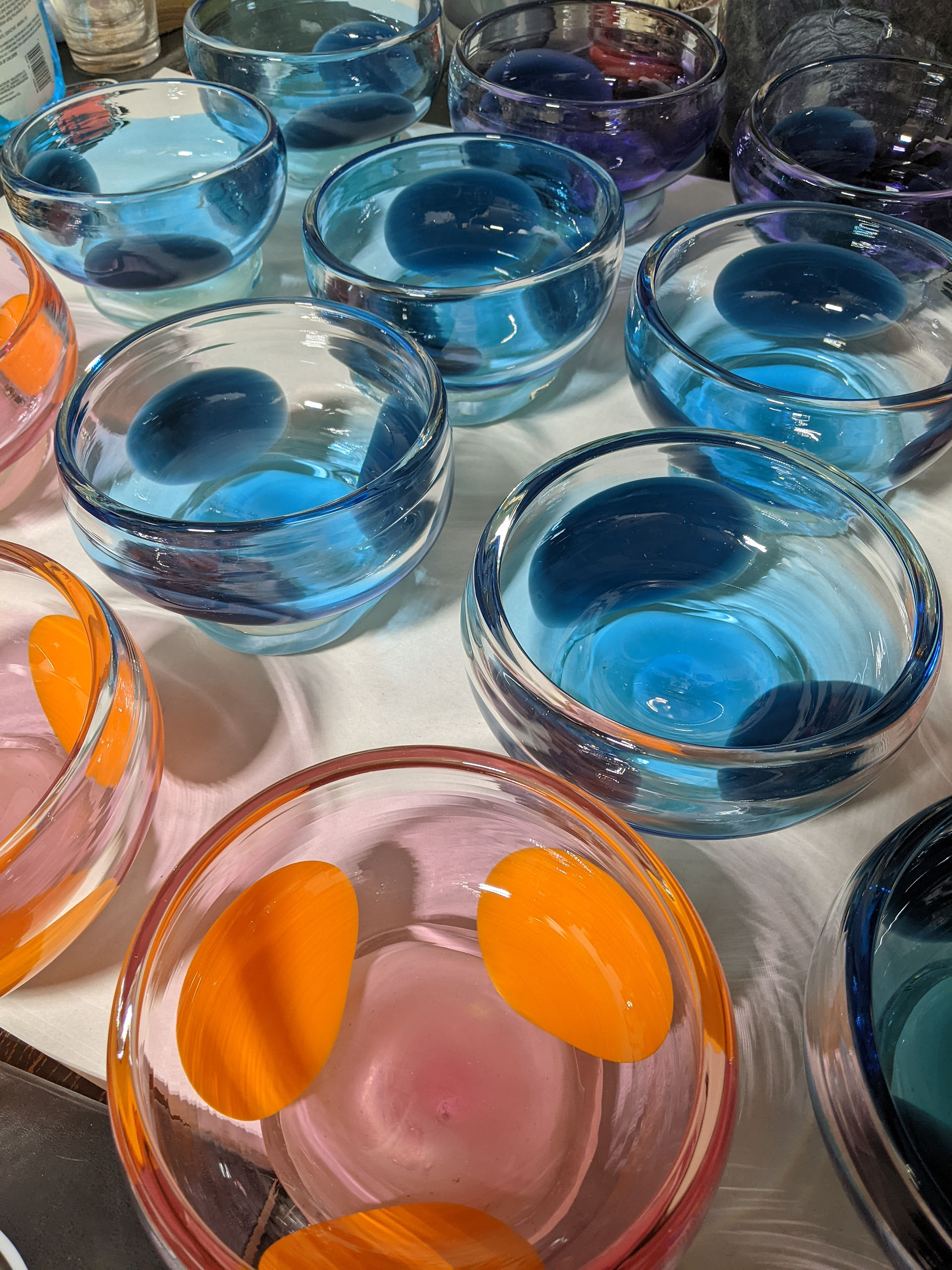 A collection of bowls I made for Ssense, they are blue and orange handmade glass catchalls. 