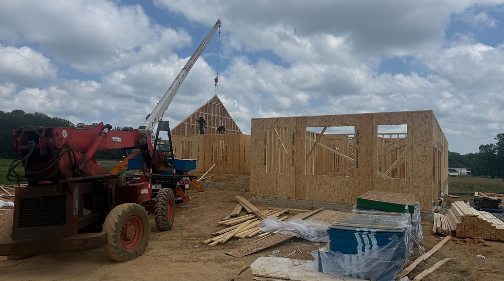 Construction site with crane and framed house