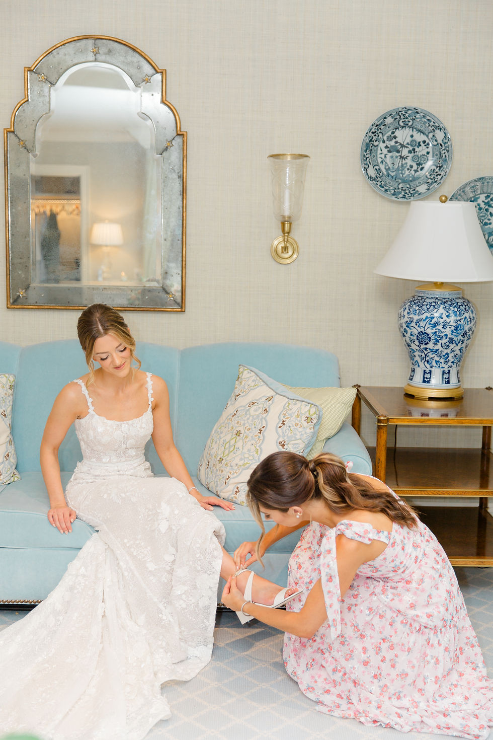 maid of honor helping bride put on shoe at vermont wedding