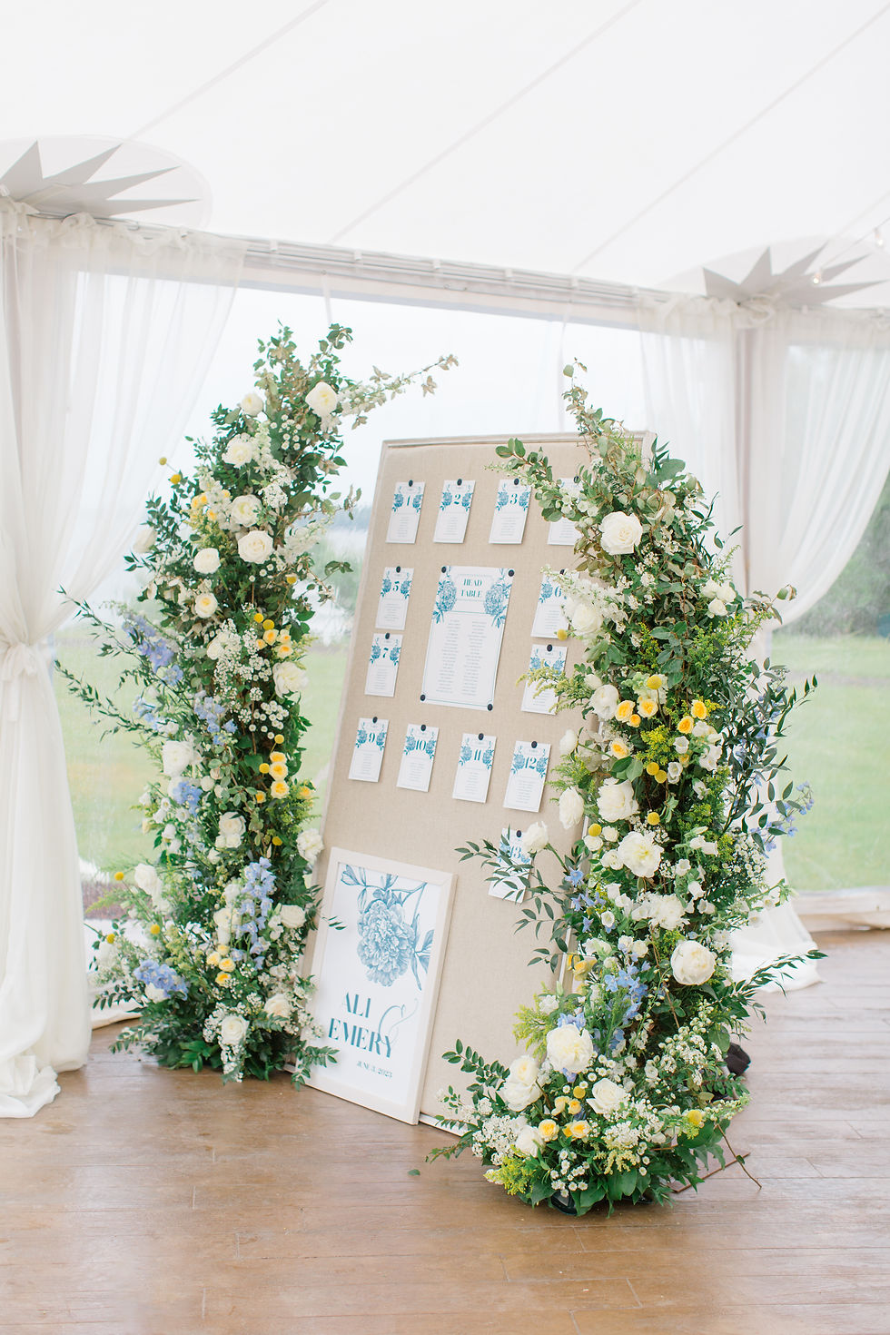 flower arch seating chart at maine tented wedding