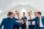 groomsmen cheers while getting ready