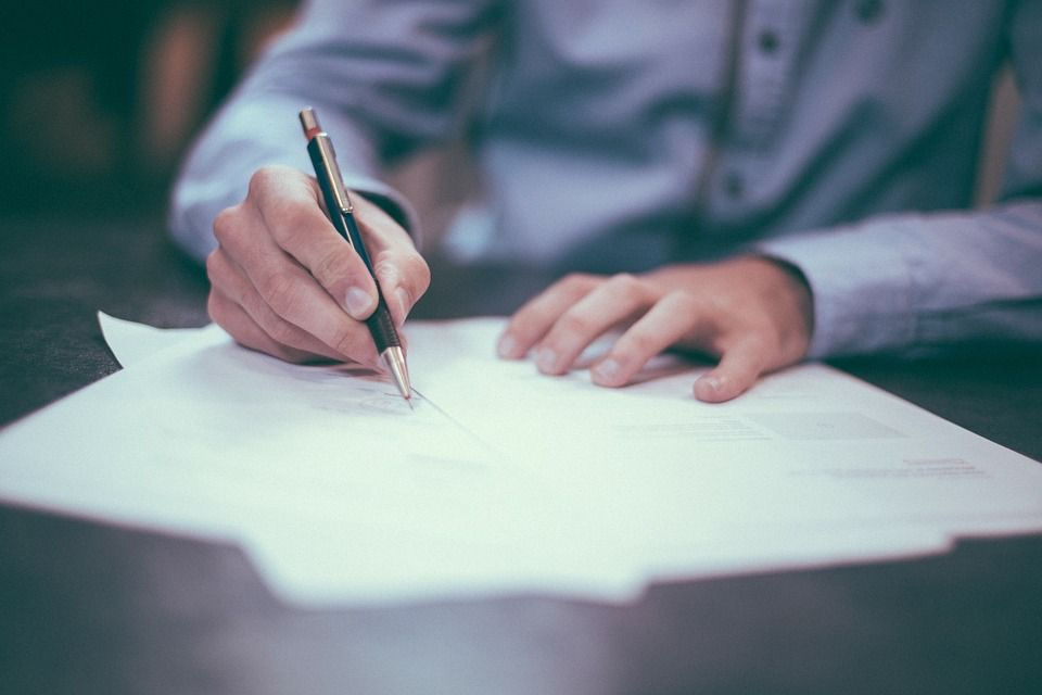 Hand writing down on pieces of paper