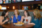Guests enjoying nachos and drinks at Bobby V's.