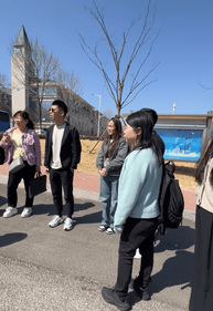 hey-rocket-standing-outside-campus-during-china-visit-on-a-clear-sunny-day