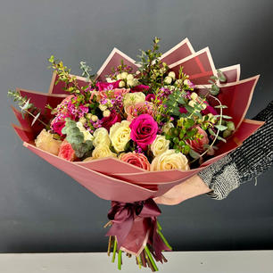 Wrapped bouquet of 3 Dozen roses in mixed shades of pink and white with accent fillers.