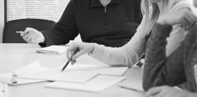Recruiters evaluating a senior candidate's professional brand and candidacy around the table.