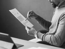 Job seeker comparing his resume and LinkedIn profile to ensure alignment before applying for jobs.