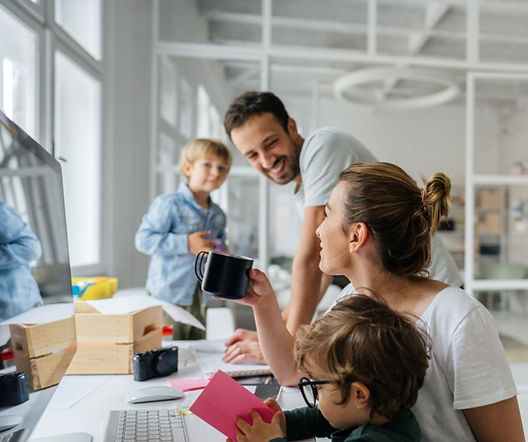 Busy family in the home gathered around a computer