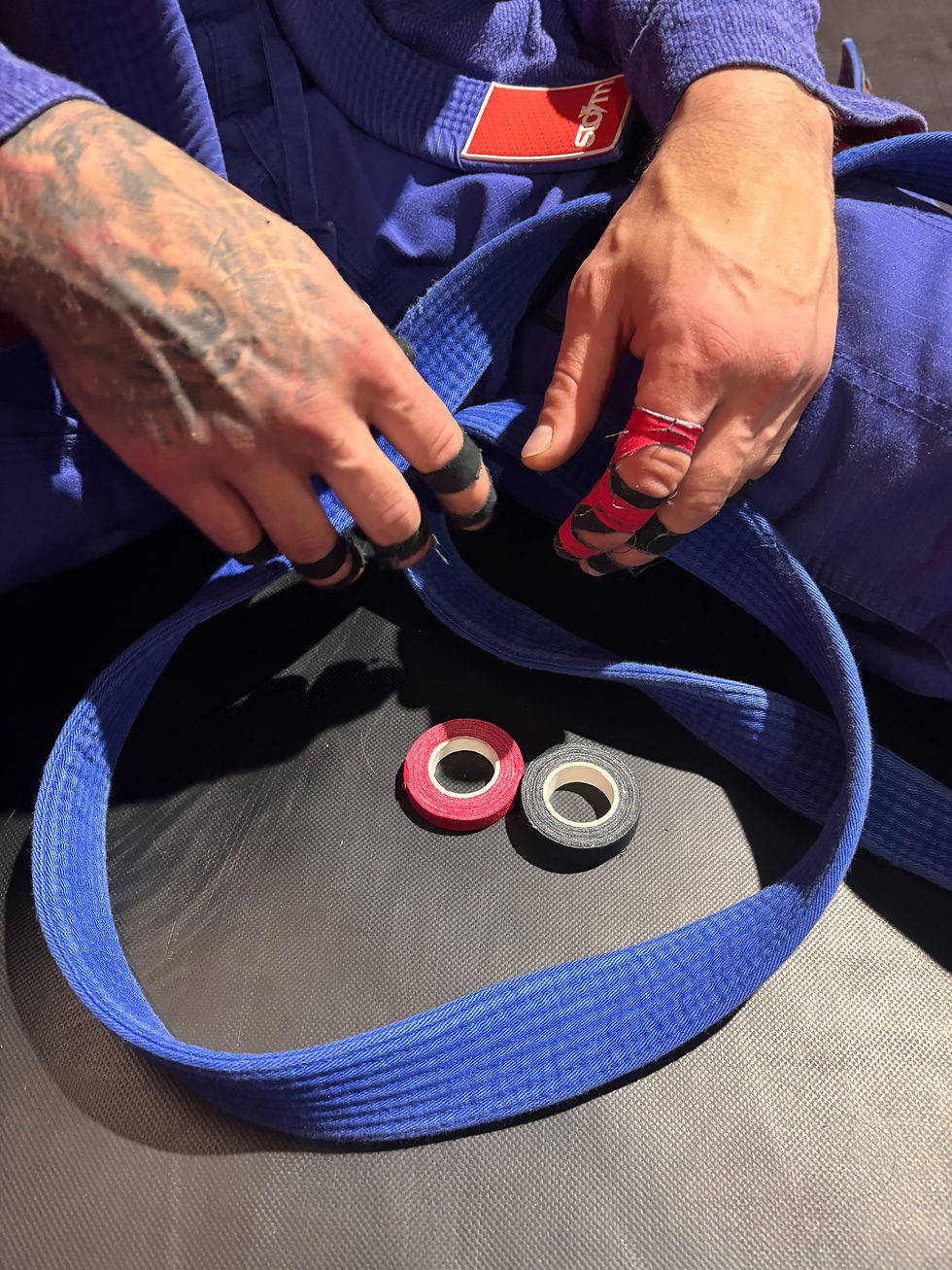 Close-up view of finger tape roll on a training mat