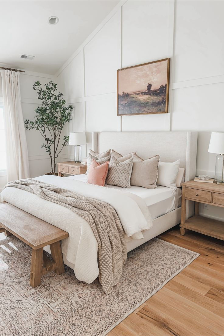 neutral white, beige blush pink bedroom with light wood flooring and furniture