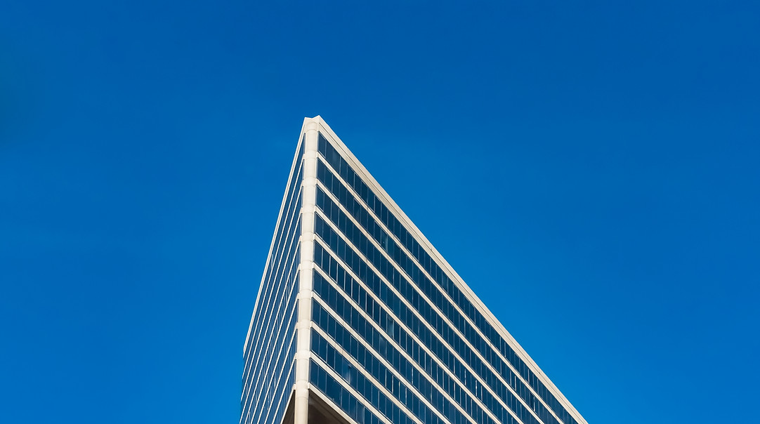low-angle-shot-tall-glass-buildings-cloudy-blue-sky.jpg
