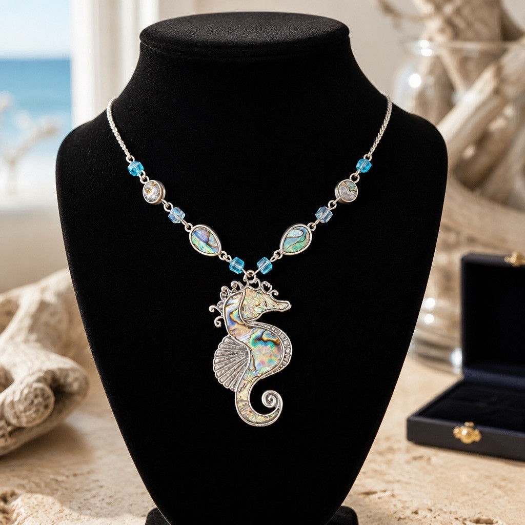 Handmade coastal necklace featuring a silver-tone seahorse pendant with abalone shell