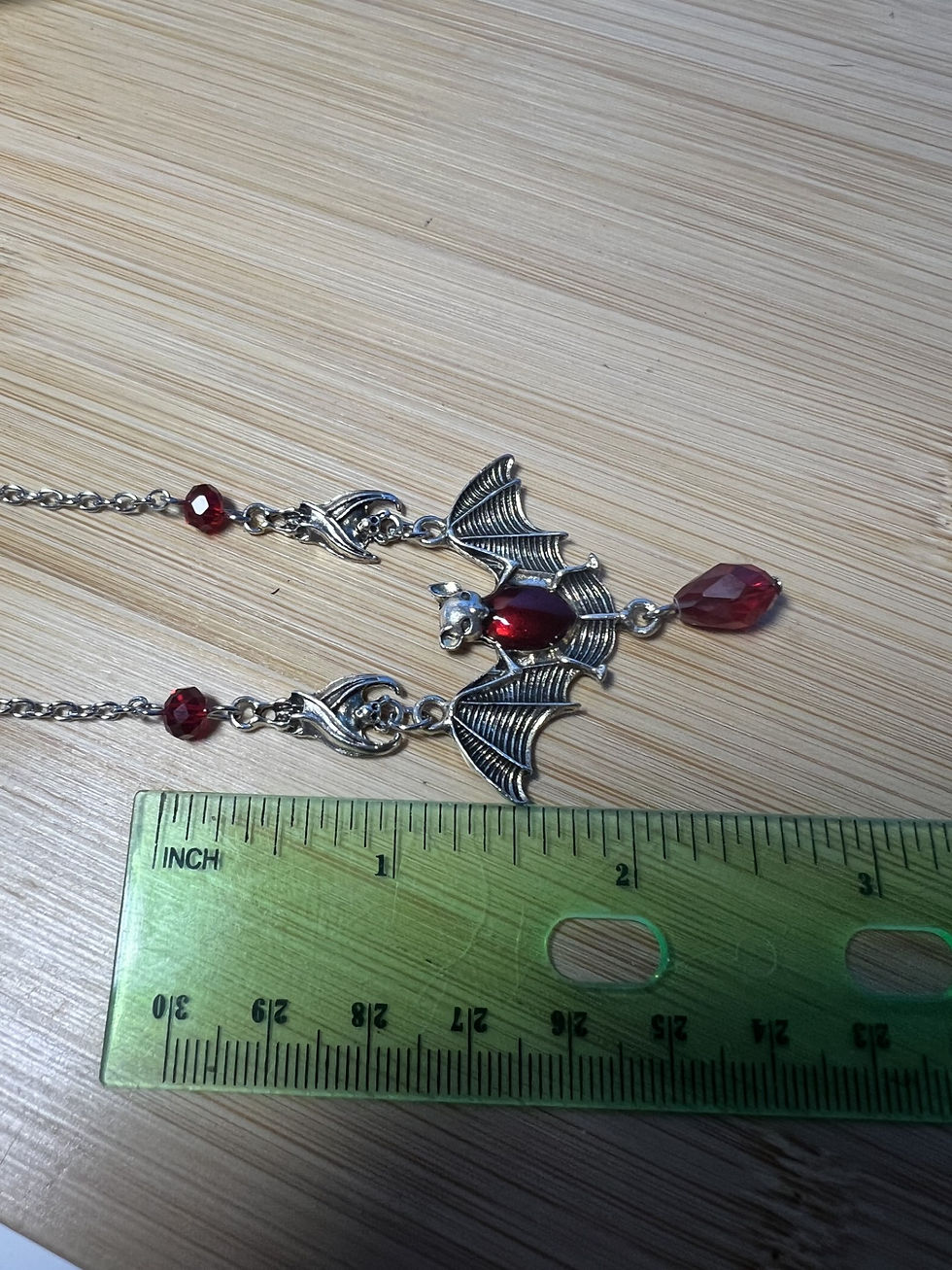 Thumbnail: Gothic silver bat necklace with red beads and dangling red teardrop length