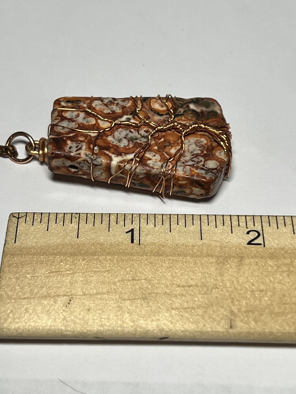 Thumbnail: Handmade leopard jasper pendant featuring a copper wire Tree of Life design across the face length