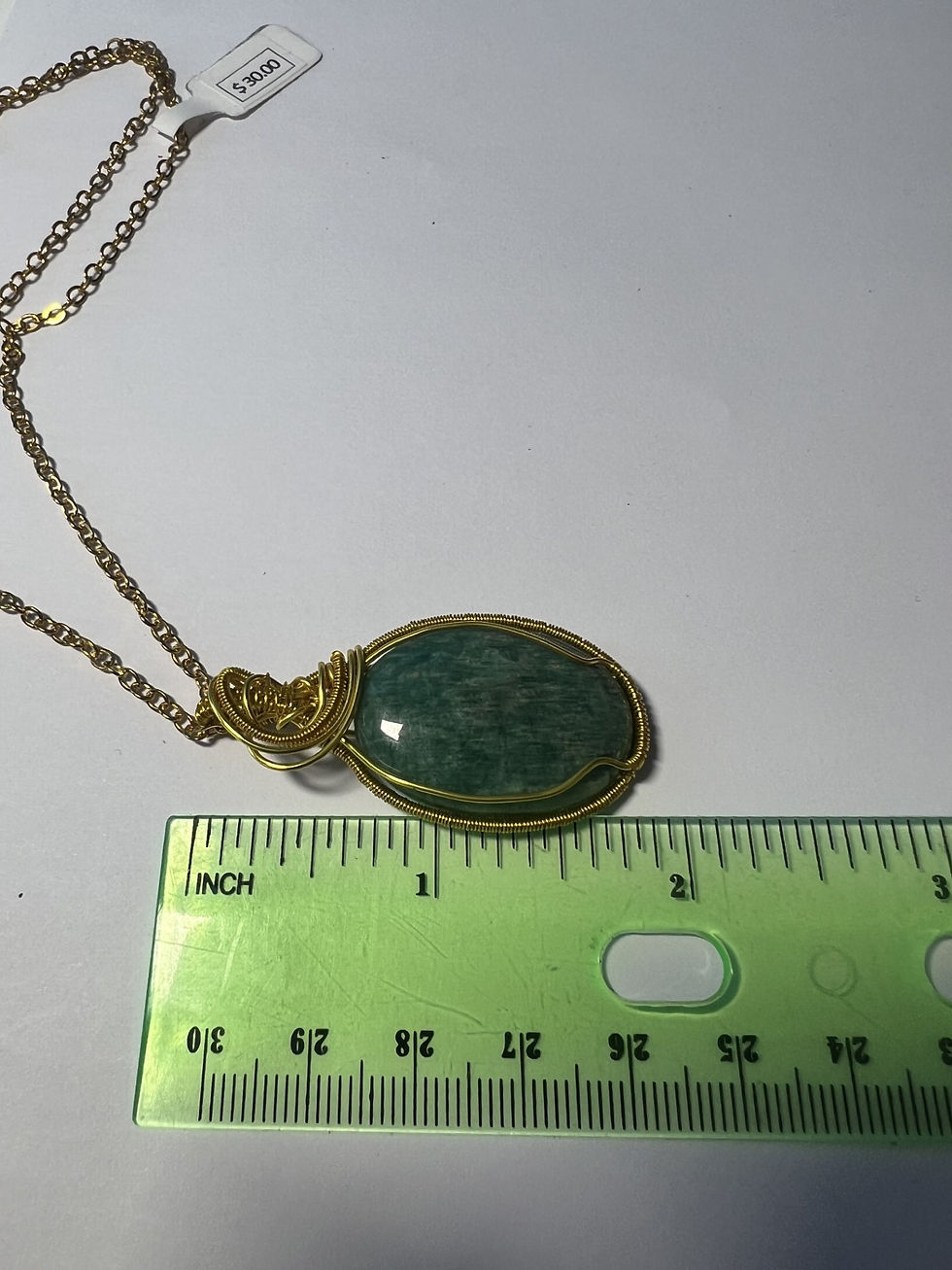 Thumbnail: Handcrafted oval green agate pendant wrapped in gold wire with elegant vine-like curves measure