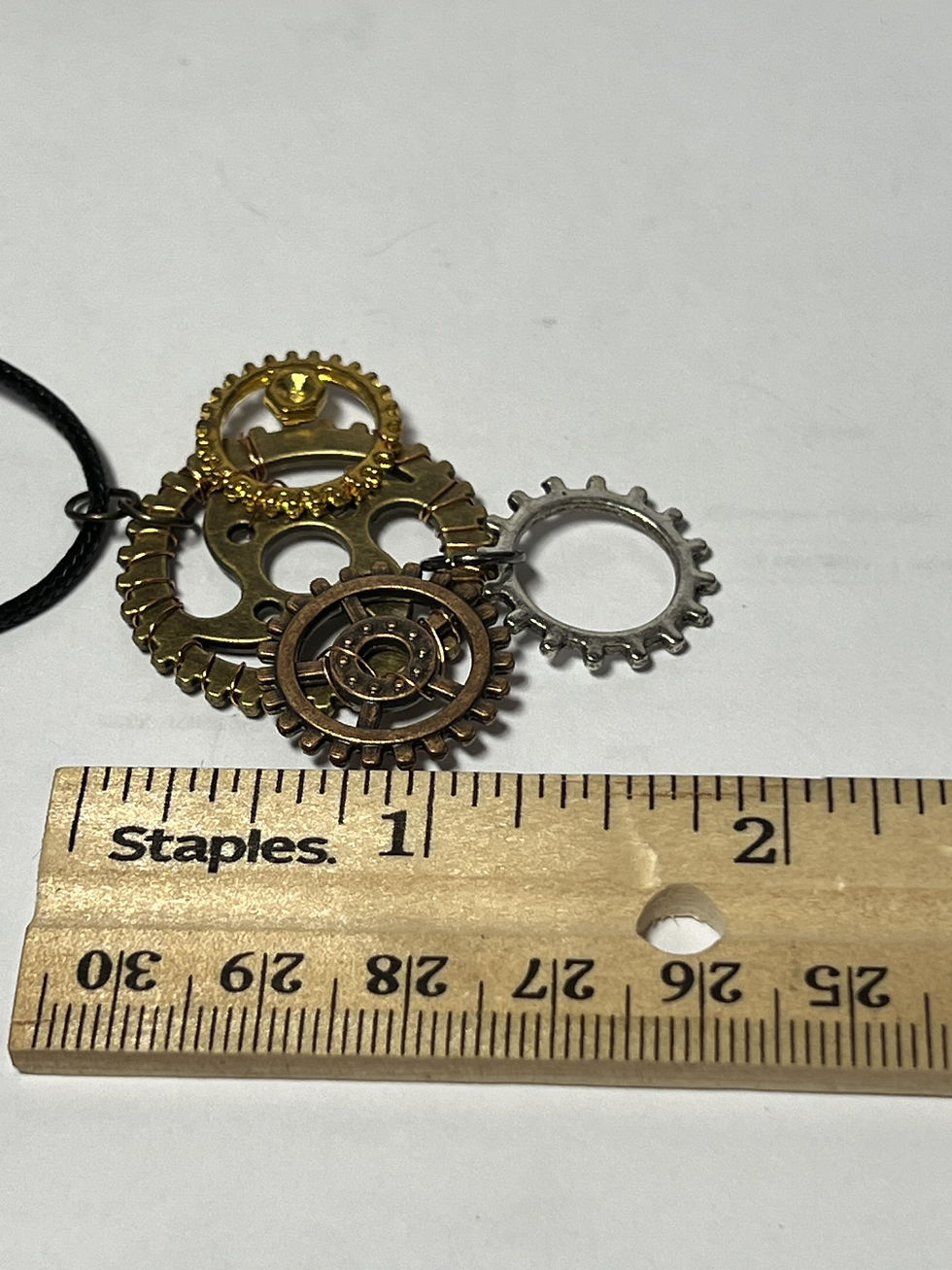 Thumbnail: Handmade steampunk necklace featuring a large bronze gear decorated with copper and gold tone gears length