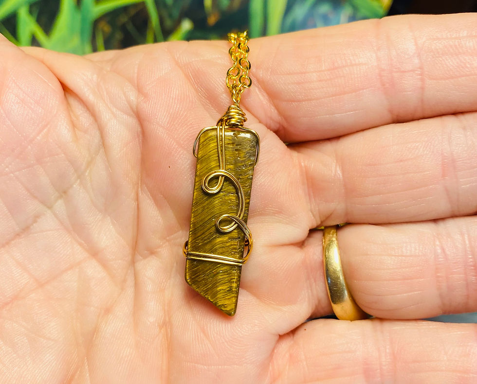 Thumbnail: Wire wrapped tiger eye necklace with gold wire in hand