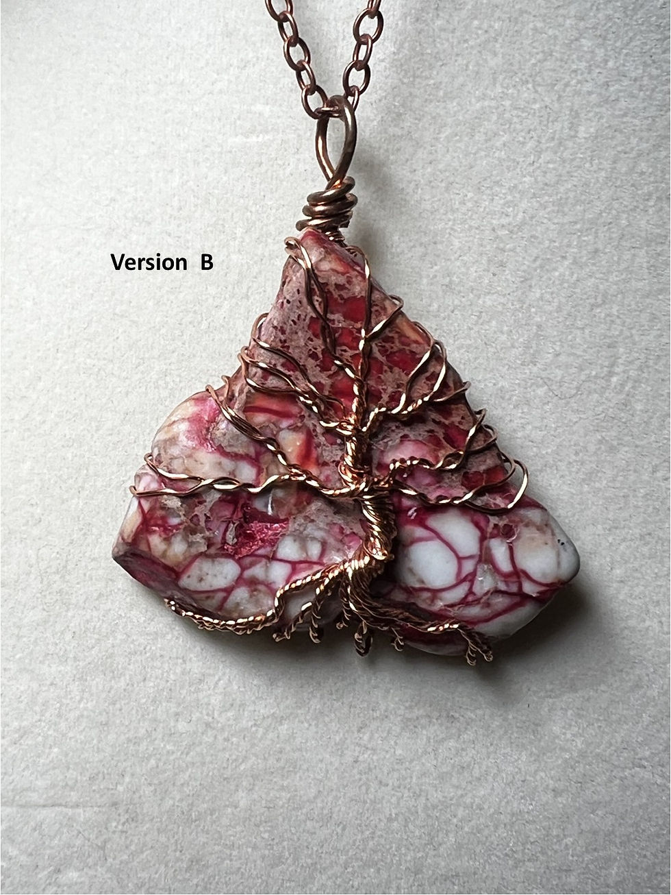 Thumbnail: Handmade red jasper pendant featuring an intricate copper wire Tree of Life design variation B