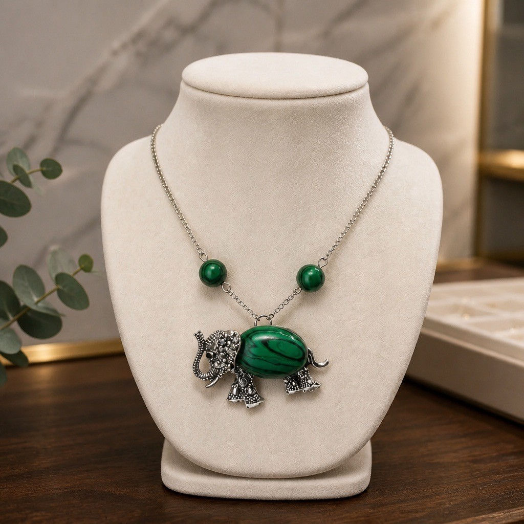 Silver elephant pendant necklace with synthetic malachite stone in the body and two matching malachite beads