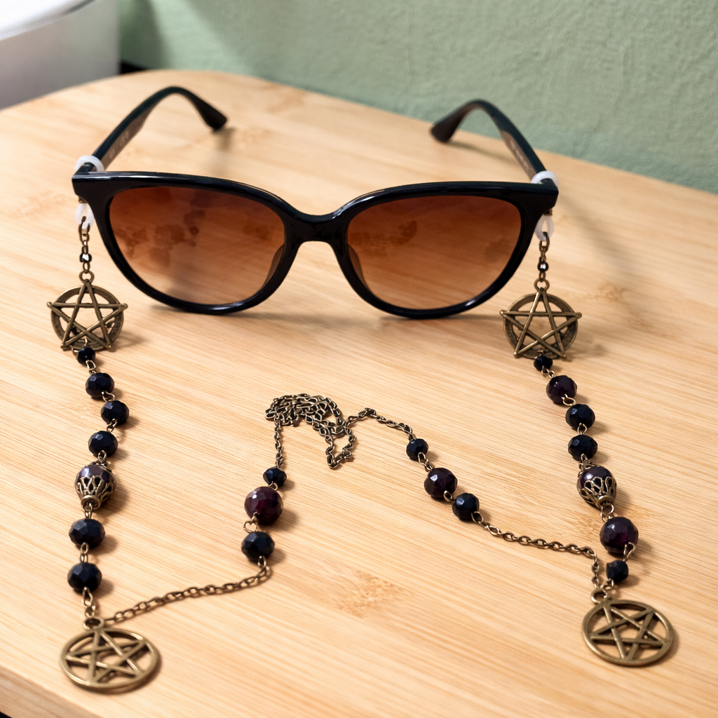 Bronze Wiccan Eyeglass chain with purple beads on table