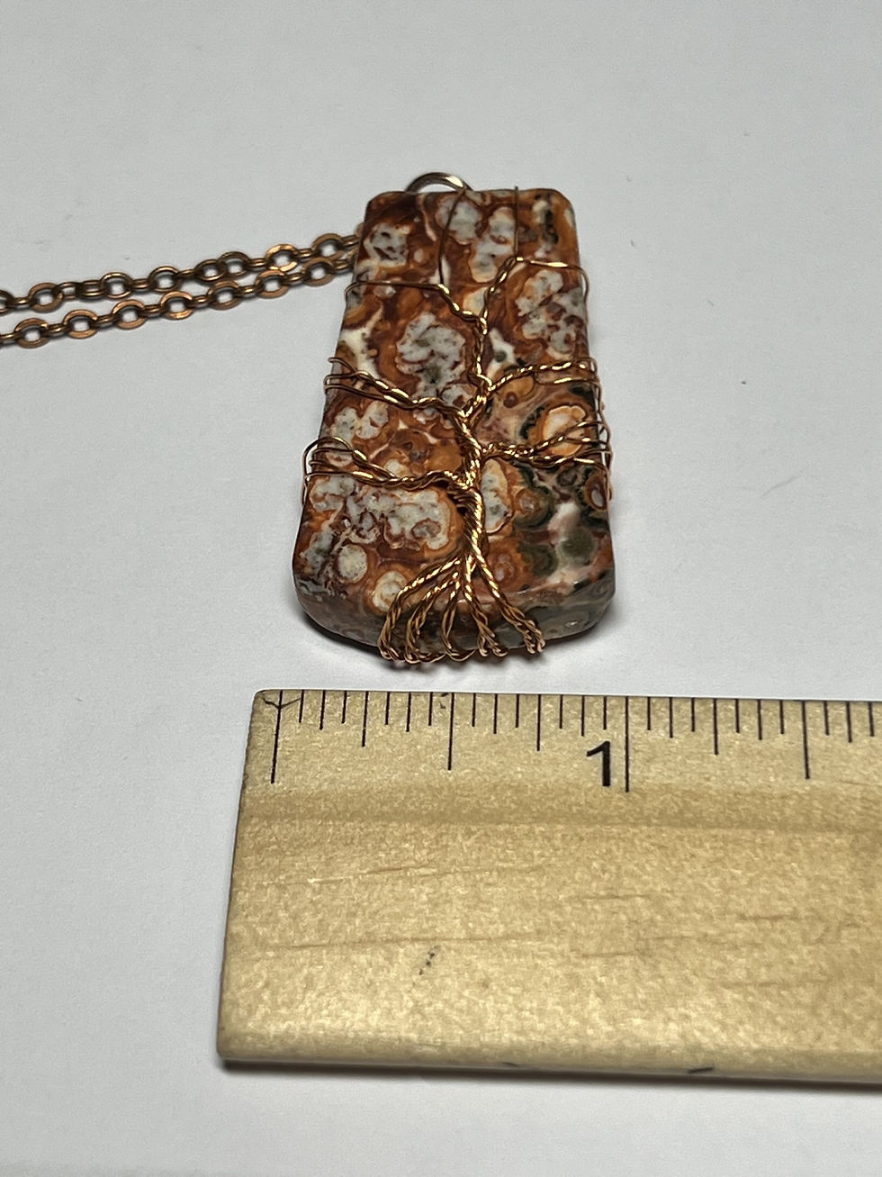 Thumbnail: Handmade leopard jasper pendant featuring a copper wire Tree of Life design across the face width
