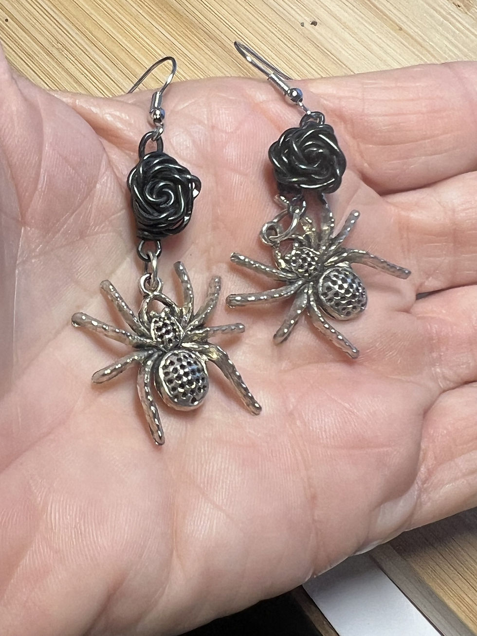 Thumbnail: Handmade spider earrings suspended from wire wrapped roses available in black, purple, or red in hand