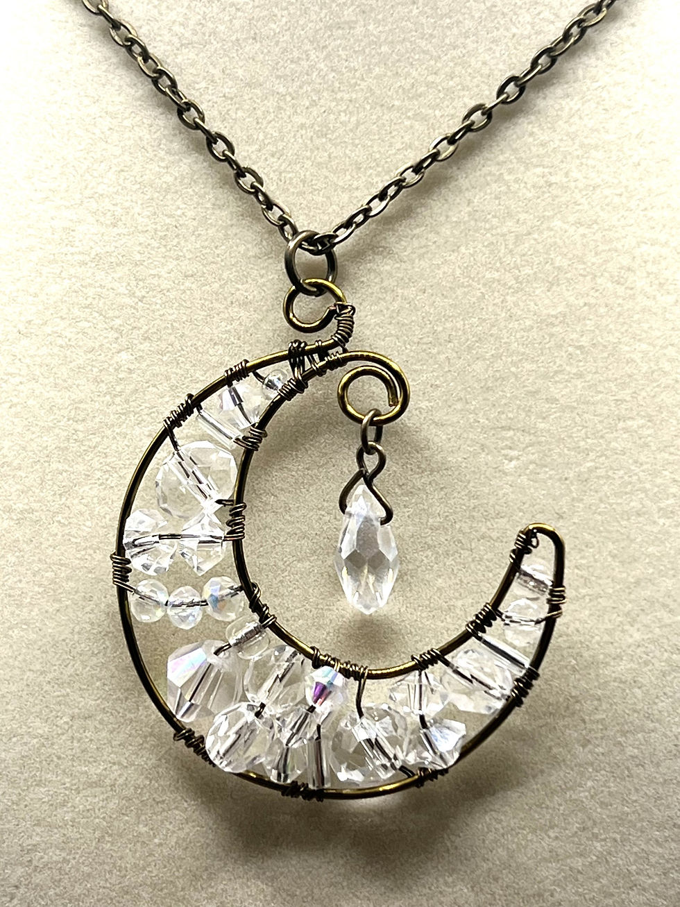Thumbnail: Bronze wire wrapped crescent moon pendant necklace with clear crystal beads and dangling crystal charm closeup