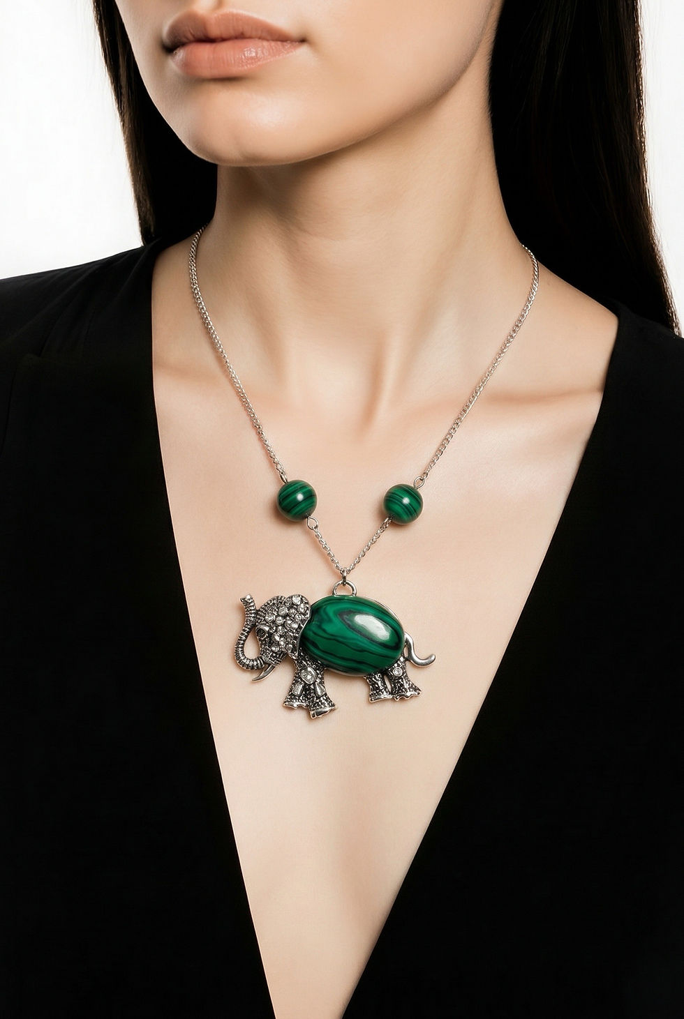 Silver elephant pendant necklace with synthetic malachite stone in the body and two matching malachite beads on model