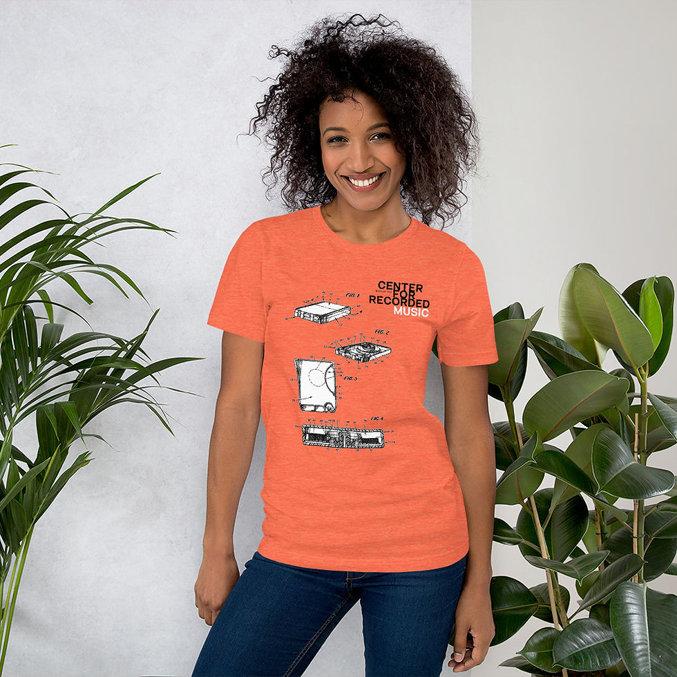 Thumbnail: Smiling woman wearing orange t-shirt with print; A Decade of Listyning shirt.