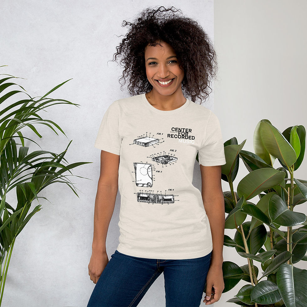 Thumbnail: Smiling woman wearing a beige t-shirt with stylized graphic designs and text.