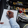 black-man-working-with-server-cabinet-in-data-cent-2025-03-10-04-47-26-utc.jpg