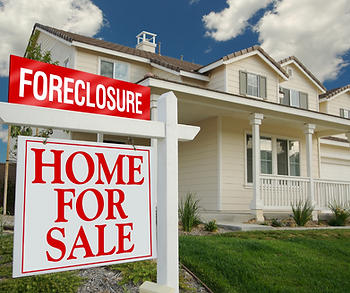 for sale and foreclosure sign in front of home