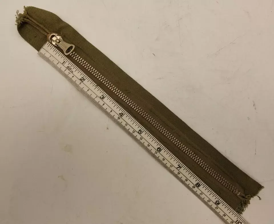 Thumbnail: La cerniera Vintage Military TALON in ottone è un accessorio di alta qualità, realizzato negli Stati Uniti. Caratterizzata dal suo stile robusto e resistente, questa cerniera rappresenta un esempio classico di design militare, ideale per chi cerca un dettaglio vintage autentico o un componente durevole per abbigliamento e accessori. La finitura in ottone conferisce un aspetto retrò e sofisticato, mentre la produzione statunitense garantisce affidabilità e standard elevati. Perfetta per riparazioni o progetti di moda con un tocco militare e vintage.
