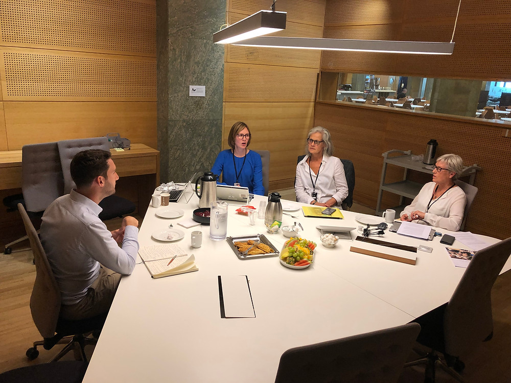 A group of ministers chat to me around a table