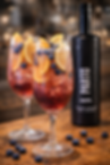 Blueberry wine spritz with orange, cranberry syrup and sparkling water garnished with citrus and blueberries