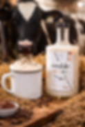 Hot coffee cocktail with acerum, maple cream and whipped cream topped with chocolate