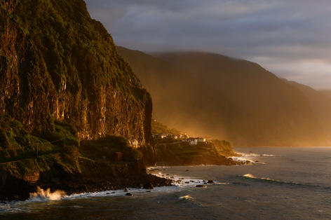 Golden sunset light hitting Madeira's steep coastal cliffs
