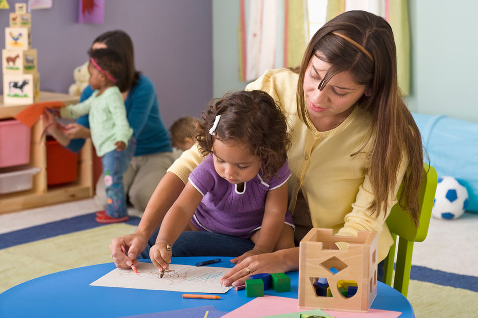 child and teacher learning to write