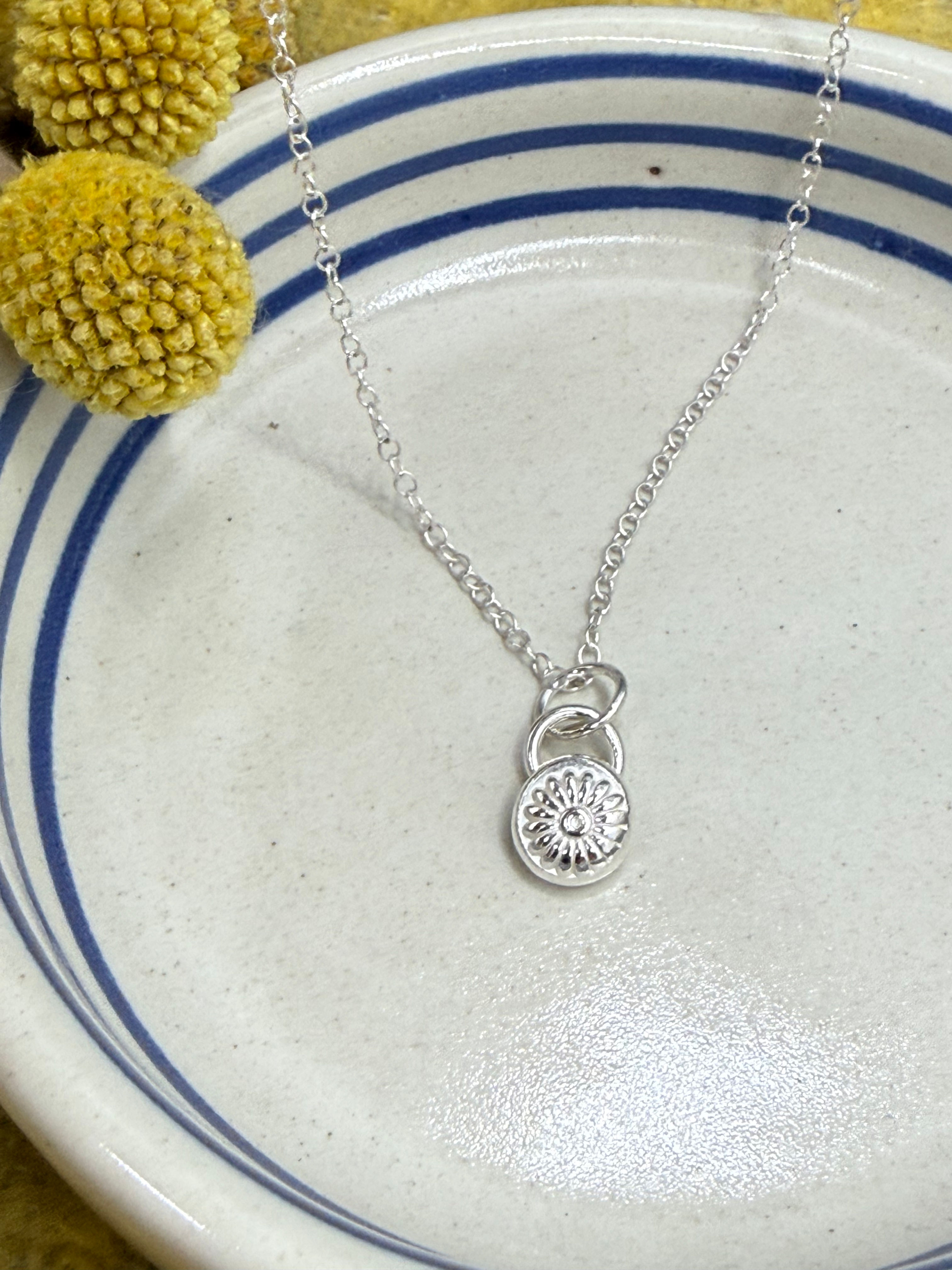 Tiny handmade silver flower pendant