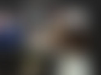 Jen of Link & Layer reviewing colors and branding options on a chalkboard wall. 