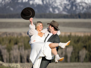Bride and groom embracing beside the beaver ponds at Schwabacher's Landing during sunrise elopement