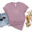 Thumbnail: Mauve blessings T-shirt flat lay with shorts, sunglasses, and sandals.